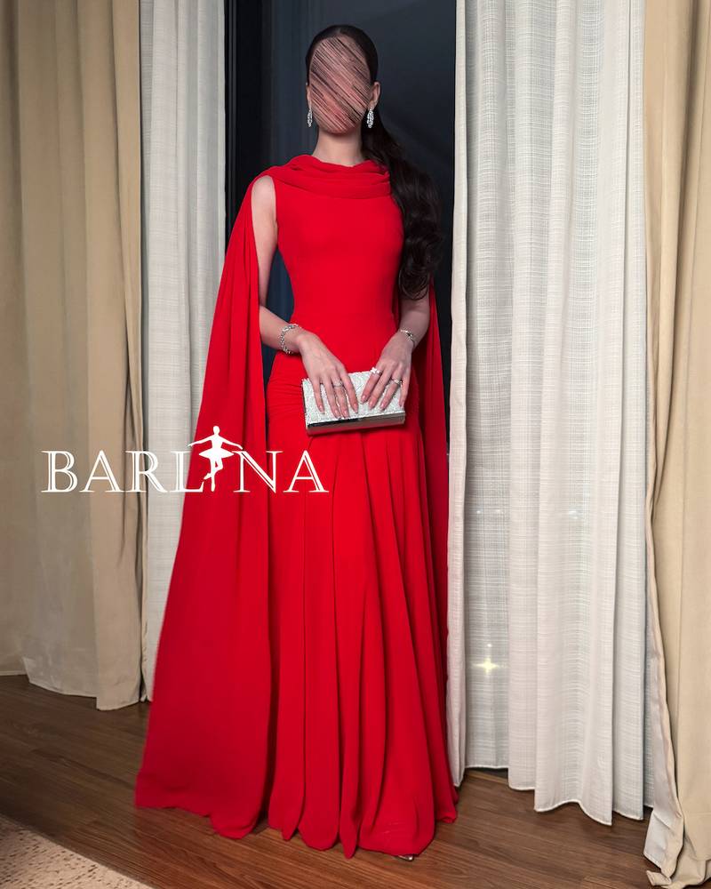Red dress with a long cape falling from the shoulders