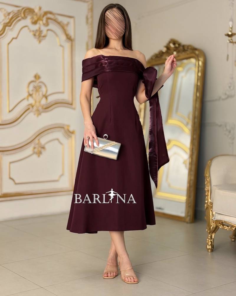 A burgundy off-the-shoulder dress with an elegant design
