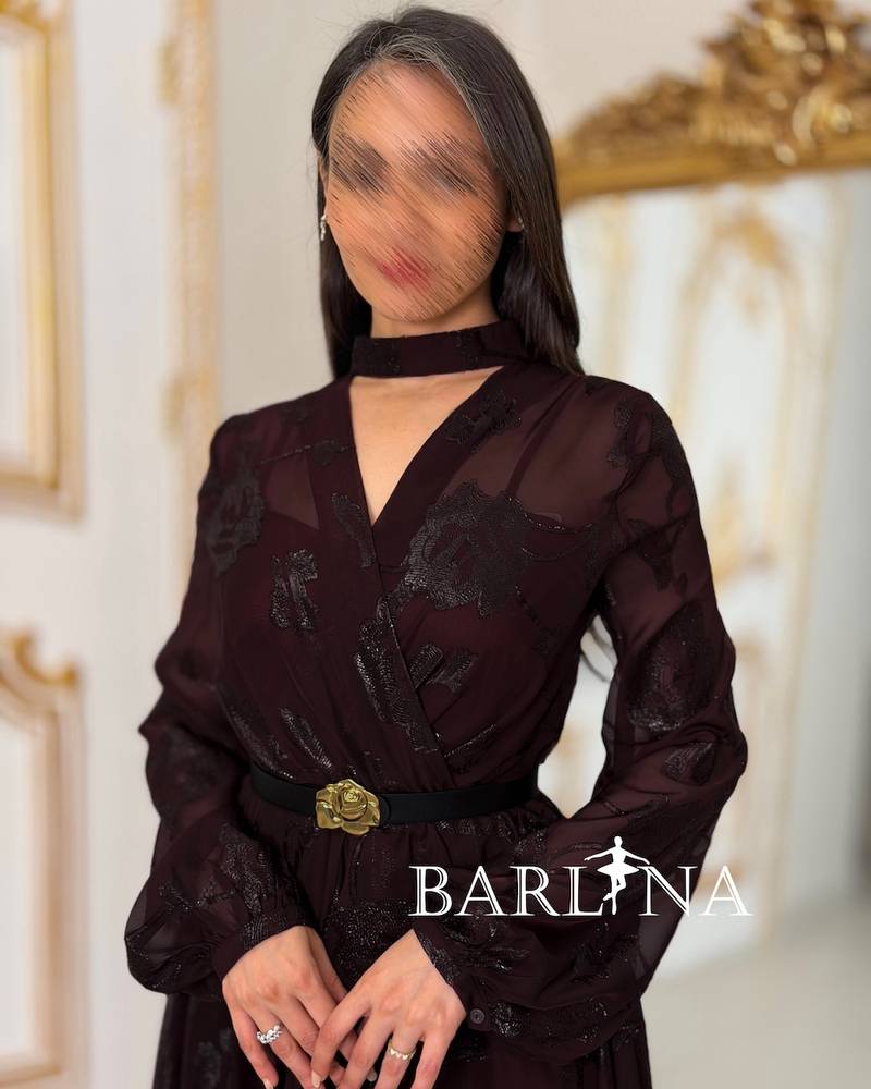 A burgundy floral dress with a gold belt