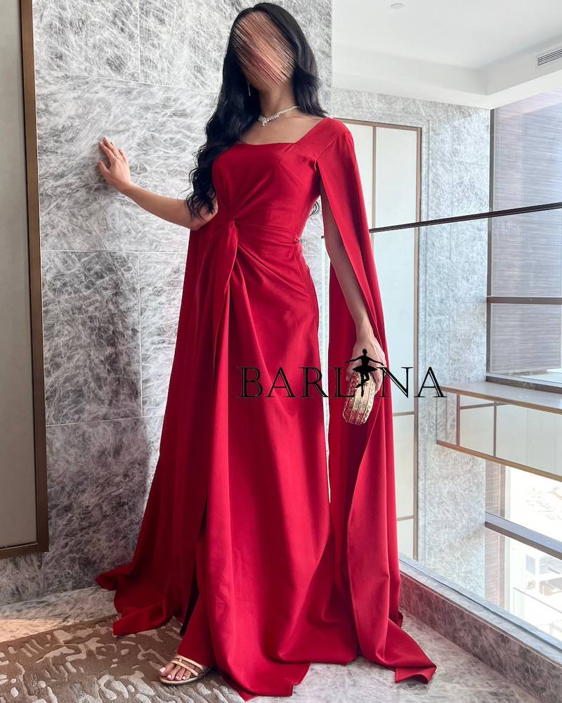 Long red dress with twisted design and cape sleeves