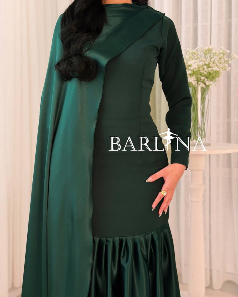 Dark green dress with an elegant cut and side train