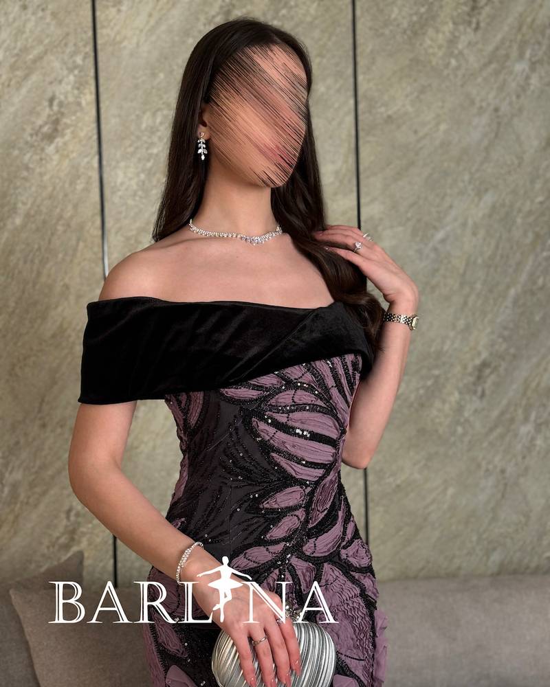 Black dress with prominent mauve embroidery