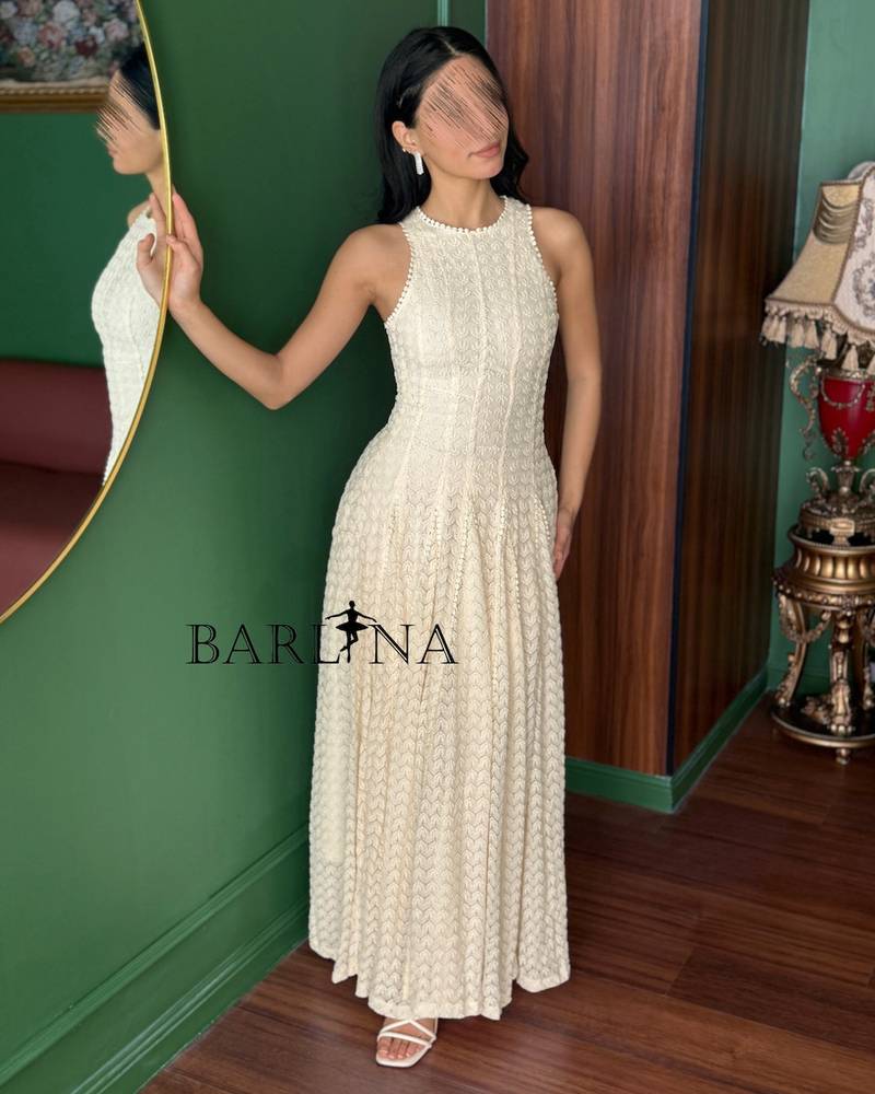 Soft off-white sleeveless dress with a flowing silhouette