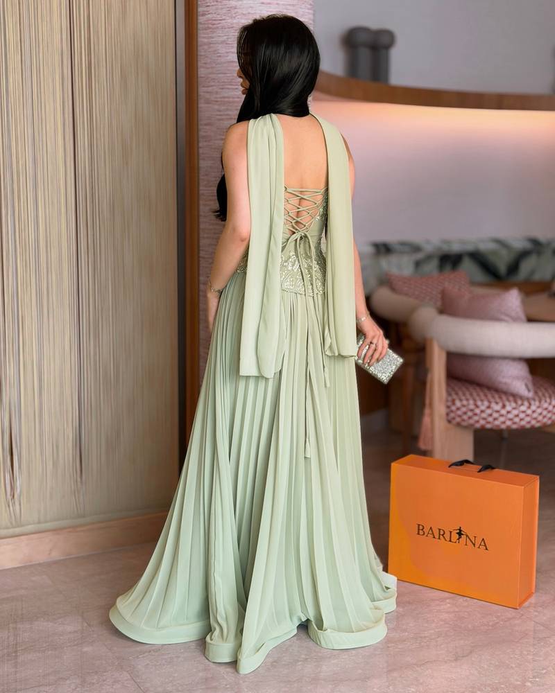Light green evening dress with a pleated hem