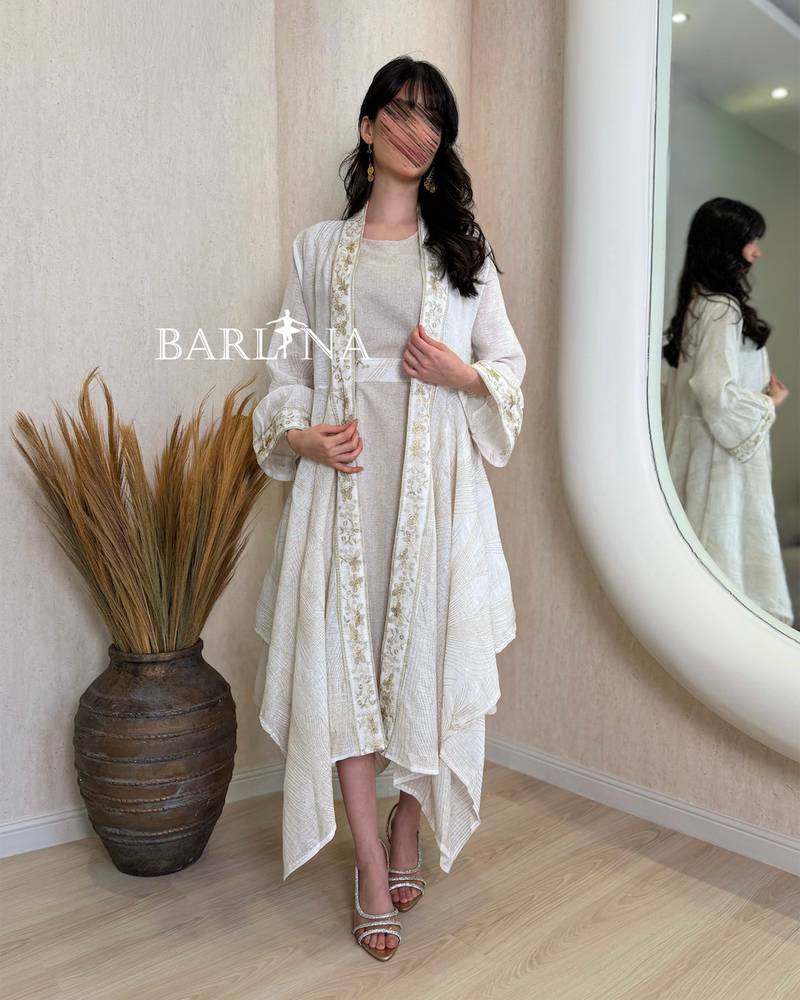 A soft jalabiya with an outer abaya featuring a gold pattern