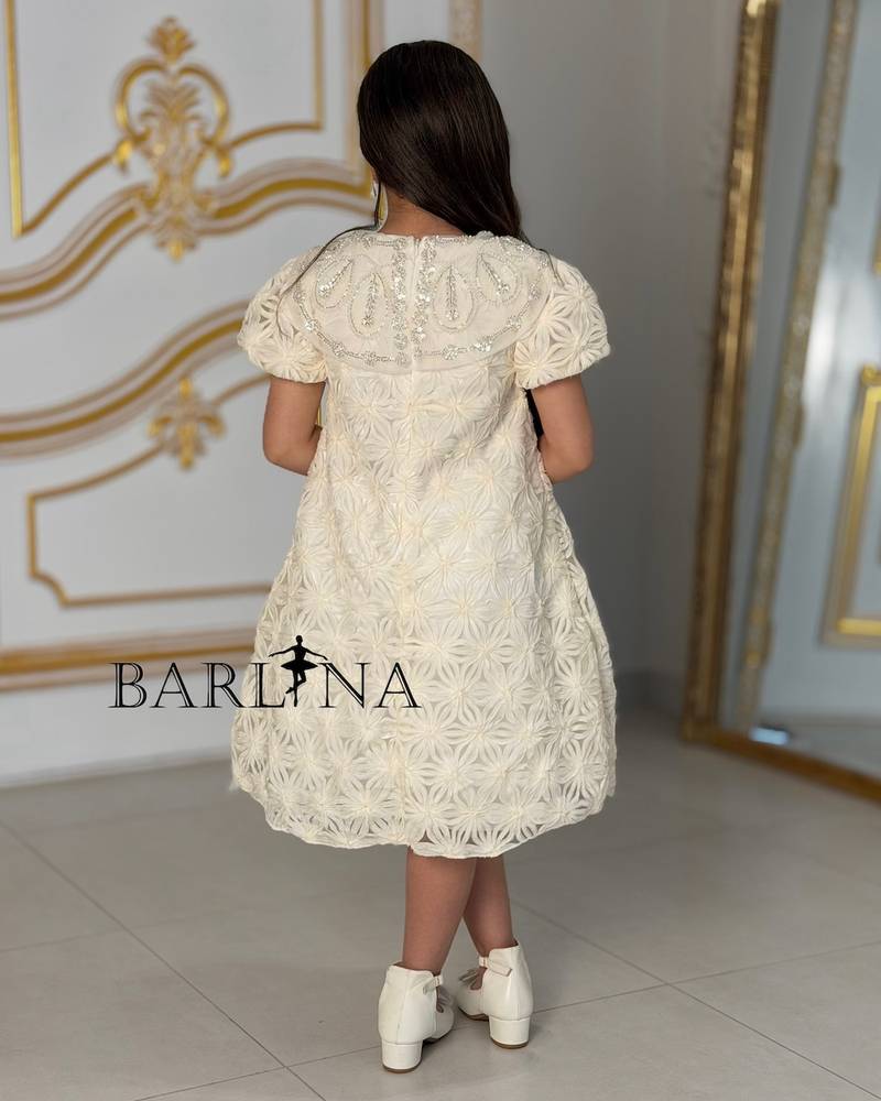 Off-white girls' dress with patterned fabric