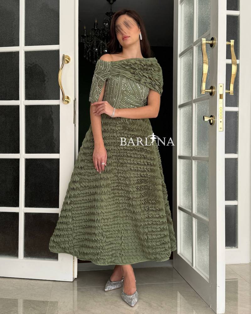 Olive green dress with a soft cut and ruffled details