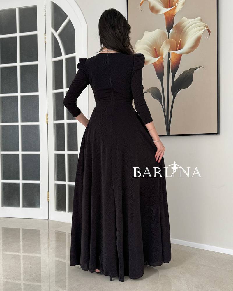 A black dress with a wide cut and elegant buttons