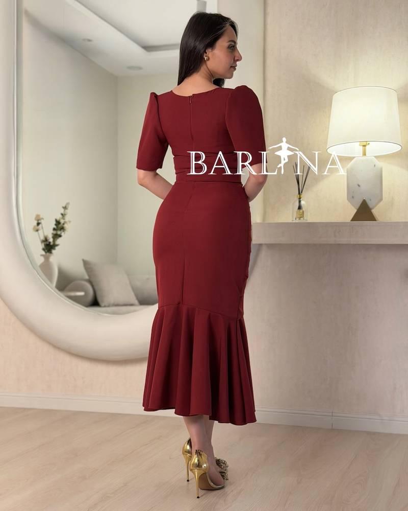 A burgundy mermaid dress with layered tiers