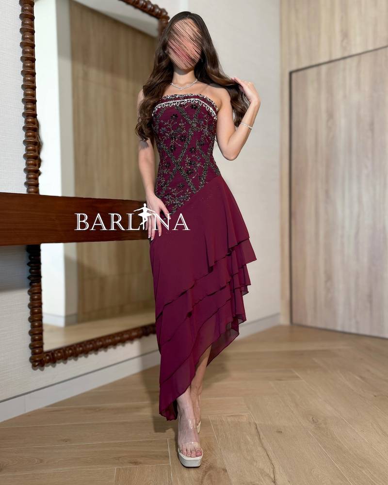 Burgundy dress with soft layers and an asymmetrical hem