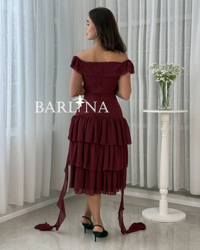 A soft, layered dress with a fabric rose.