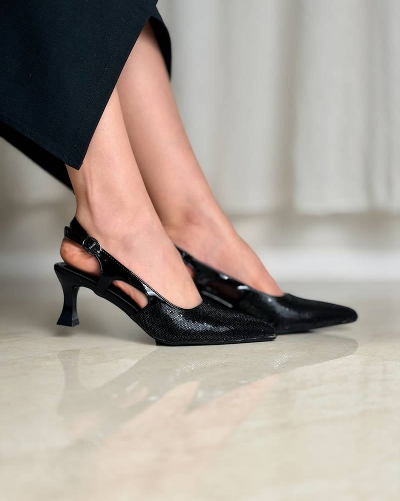 Elegant women's shoes with a thin heel and shiny details