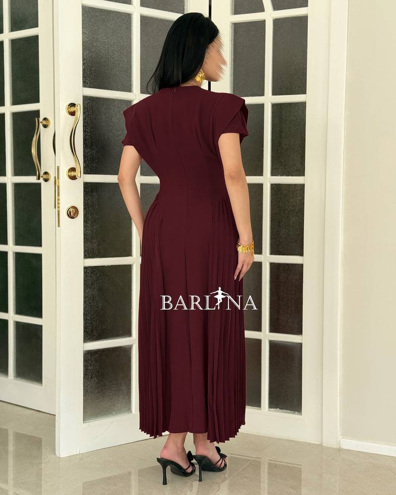 A soft burgundy dress with side pleat details