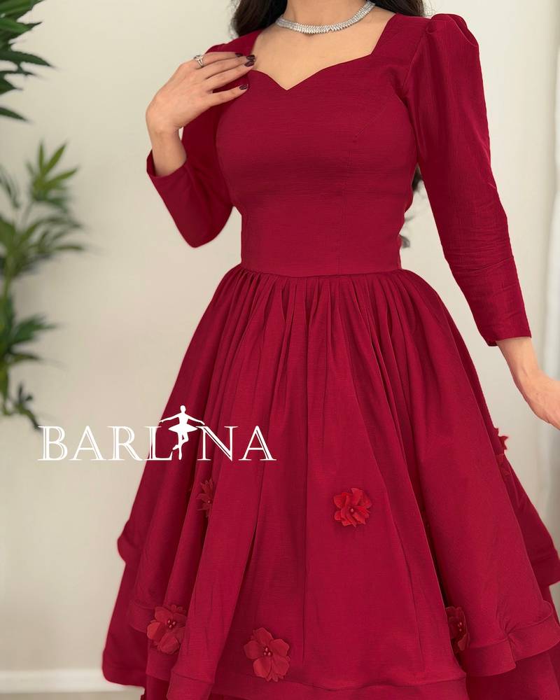 A burgundy mid-length dress with a sweetheart neckline