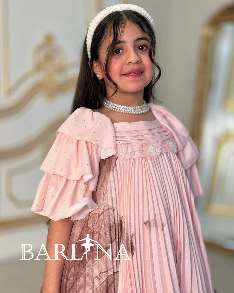 A soft girl's dress decorated with delicate prints