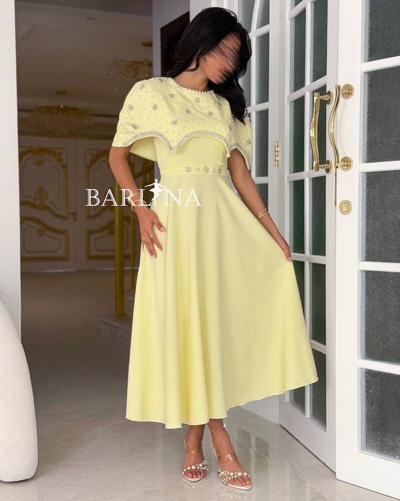 Yellow dress with an off-the-shoulder piece and a crystal belt