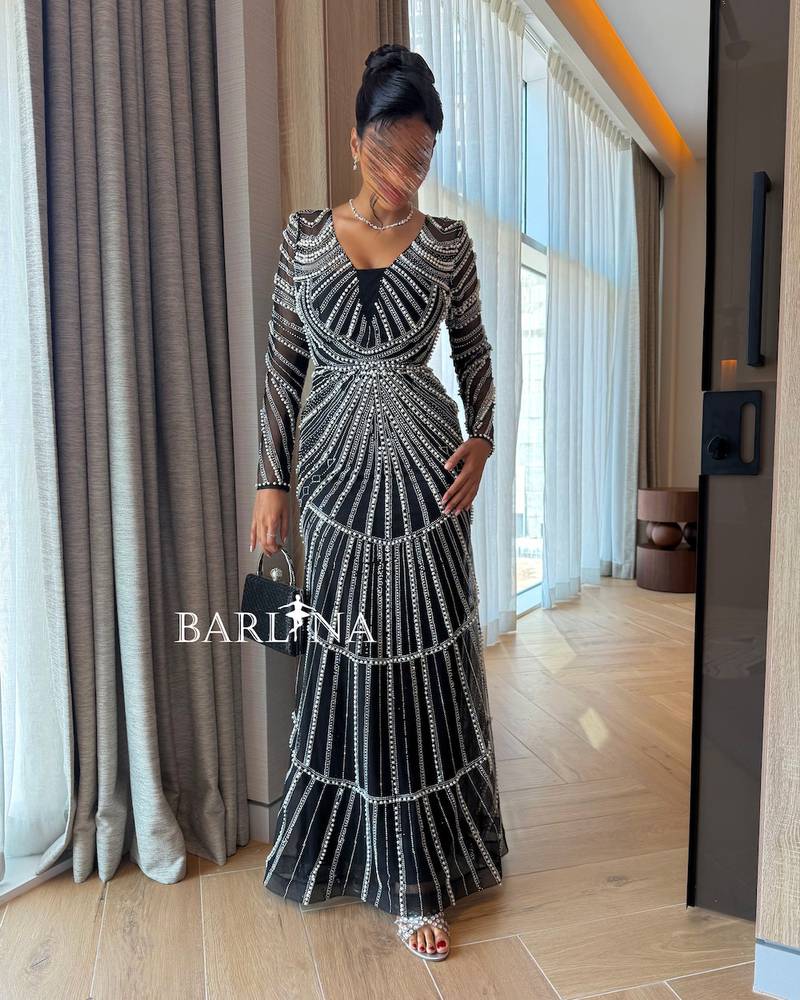 Black dress embroidered with shimmering lines