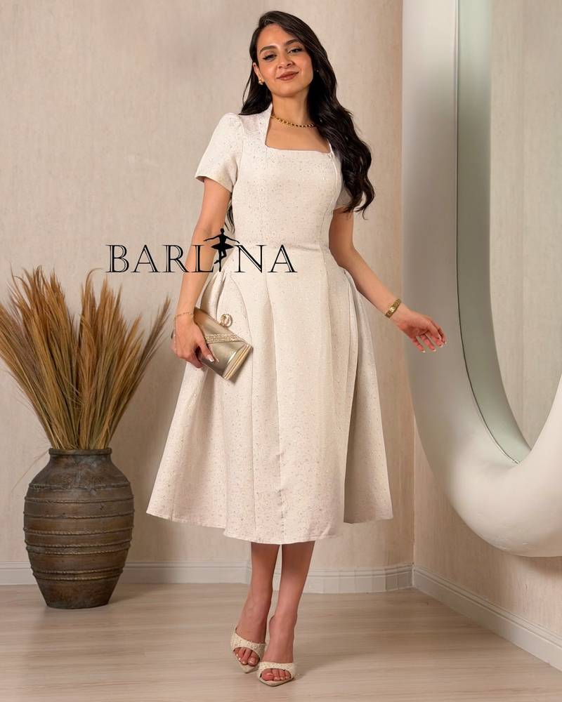 A classic off-white dress with delicate patterns