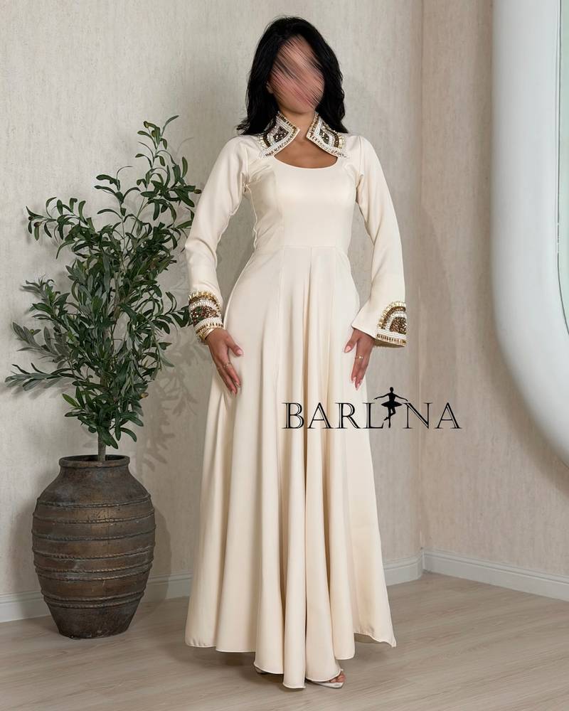 Beige dress with patterns on the neck and sleeves