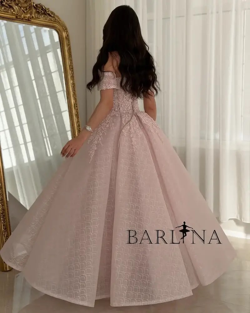 A pink puffy evening dress adorned with delicate embroidery