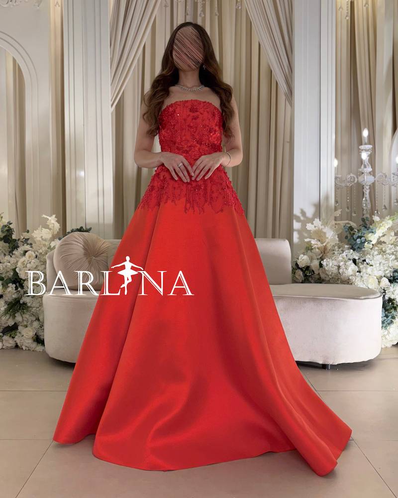 Red sleeveless dress with prominent floral patterns