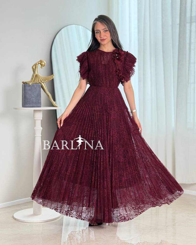 A burgundy dress made of lace fabric with ruffled sleeves