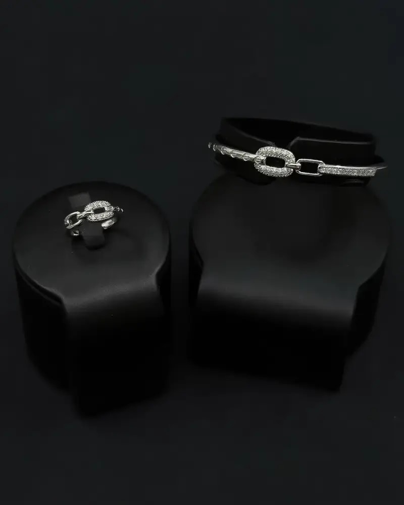 A delicate bracelet and ring with an interlocking ring design