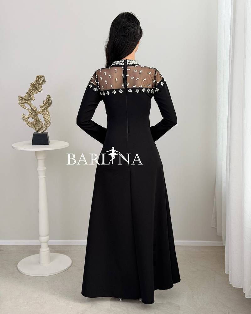 Black dress with a crystal-embroidered sheer neckline