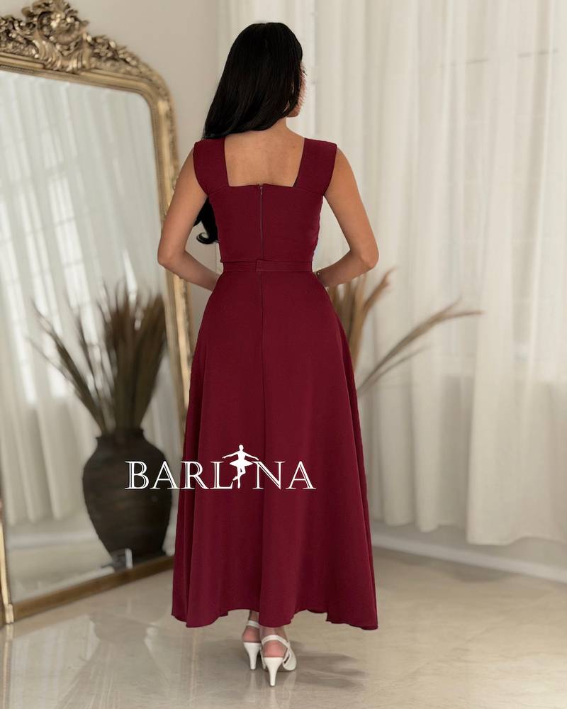 Elegant burgundy dress adorned with striking details