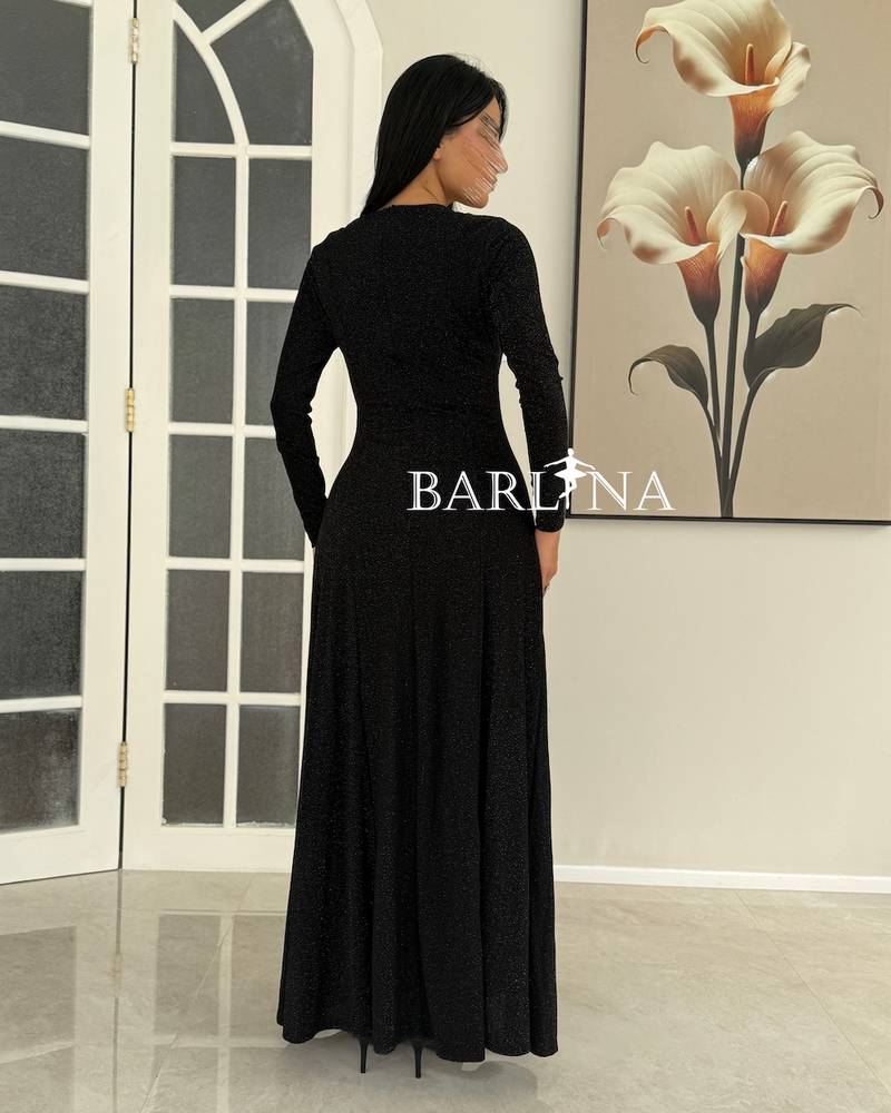A shiny black dress with a wide cut and a studded collar