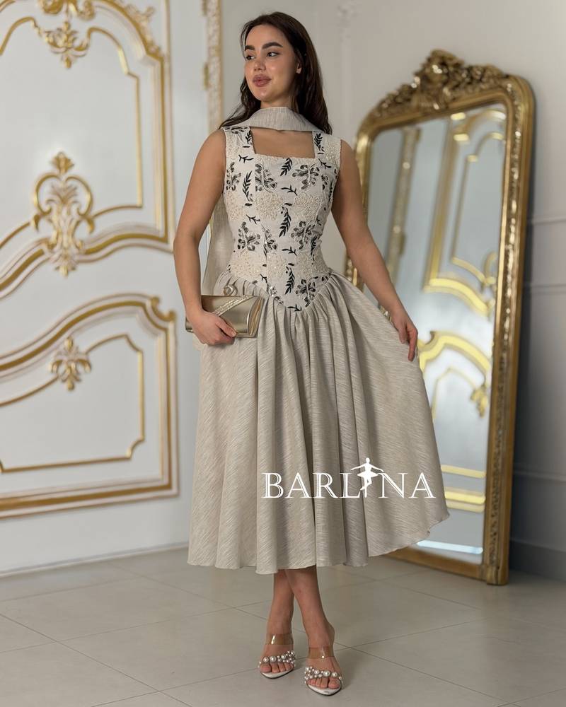Beige V-neck dress with black embroidery