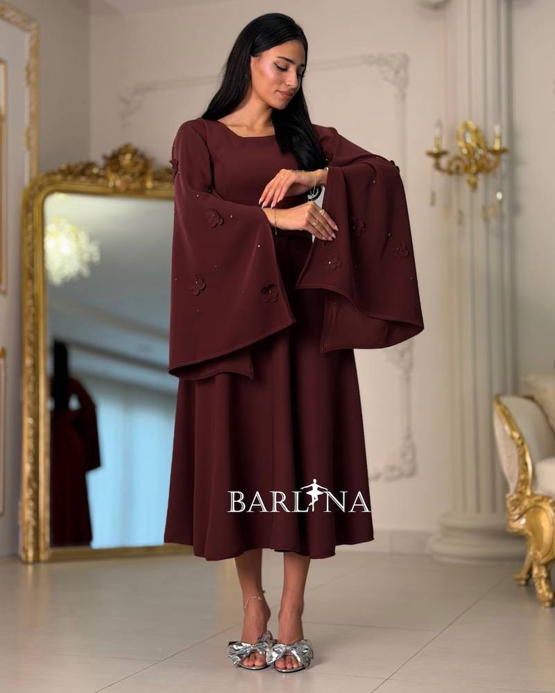 Burgundy dress with sleeves adorned with prominent roses