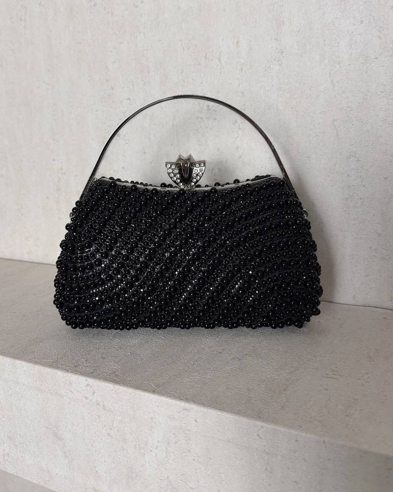 An evening bag adorned with matching pearls