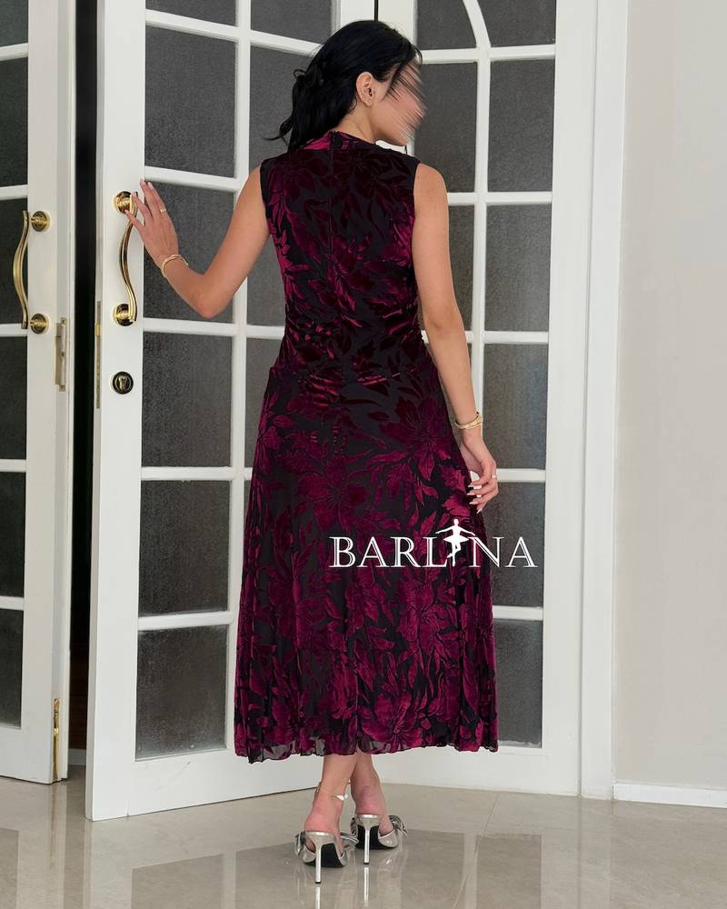 A burgundy midi dress with a rich velvet floral pattern