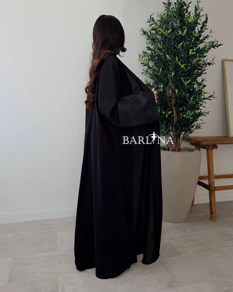 Black abaya with a flowing design and light embroidery