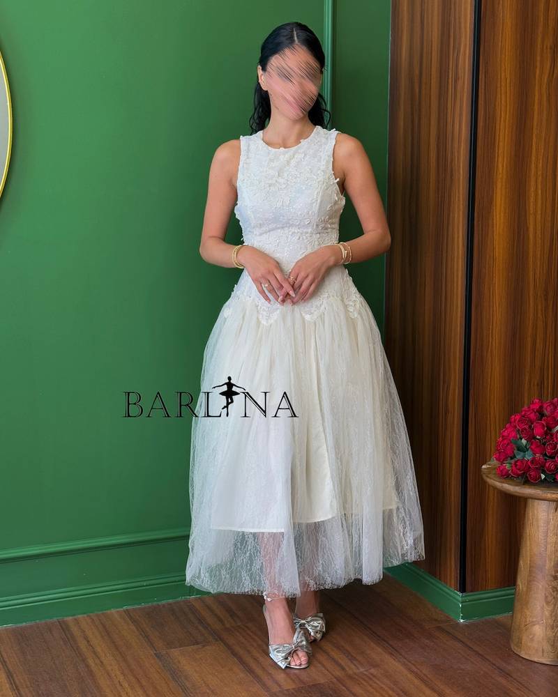 White dress with a light tulle layer over lace
