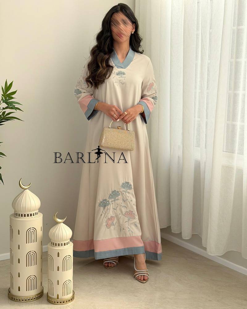 Cream-colored jalabiya with delicate embroidery and colored edges