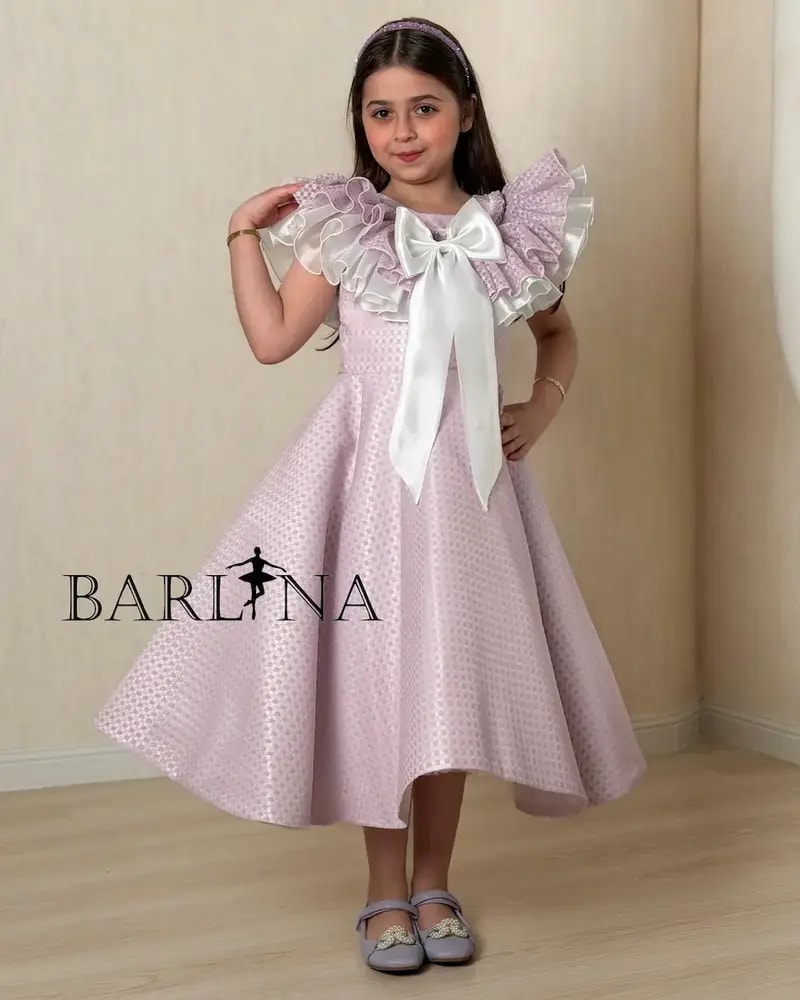 Purple girl's dress decorated with a large bow