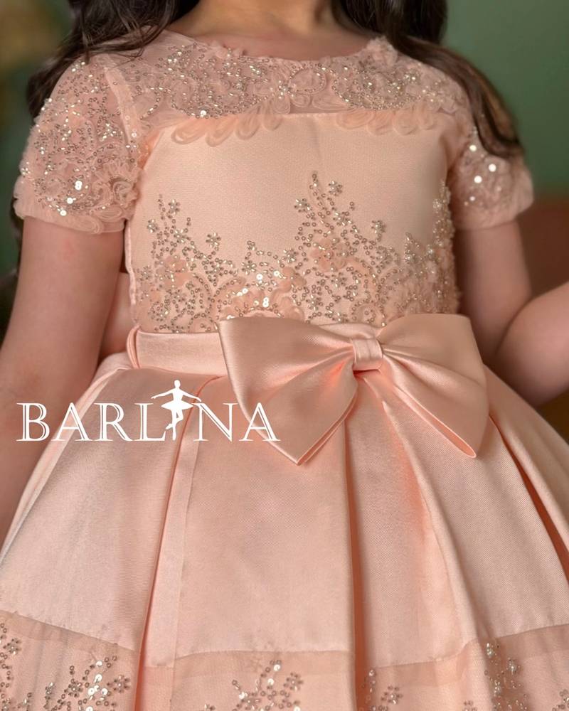 Girls' dress in a peach color with short sheer sleeves