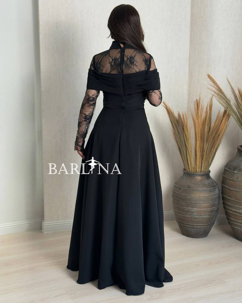 A soft black dress with sheer lace sleeves
