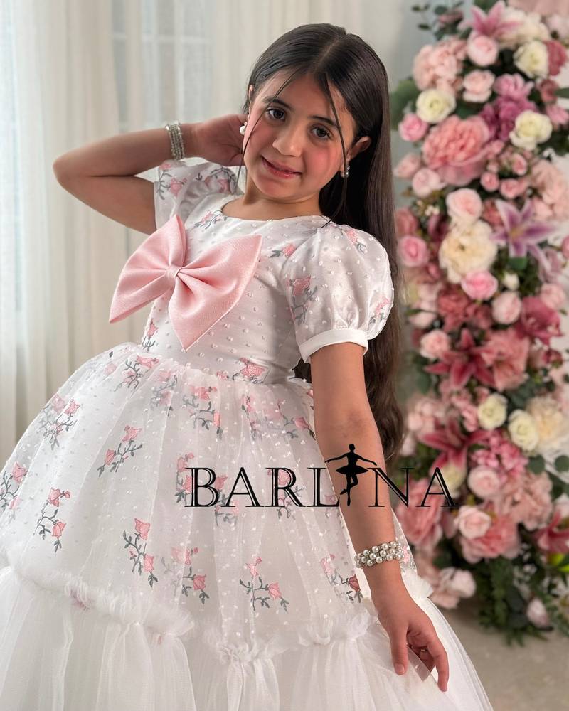 White girl's dress with embroidery and a pink flower