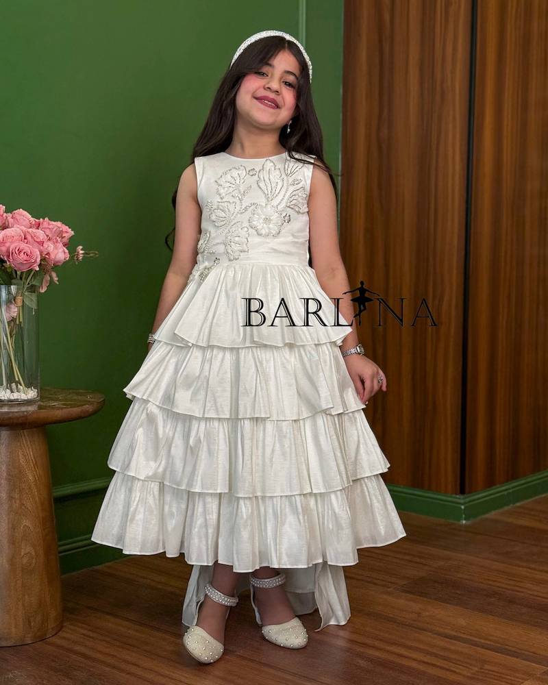 White girls' dress with ruffled layers and delicate embroidery