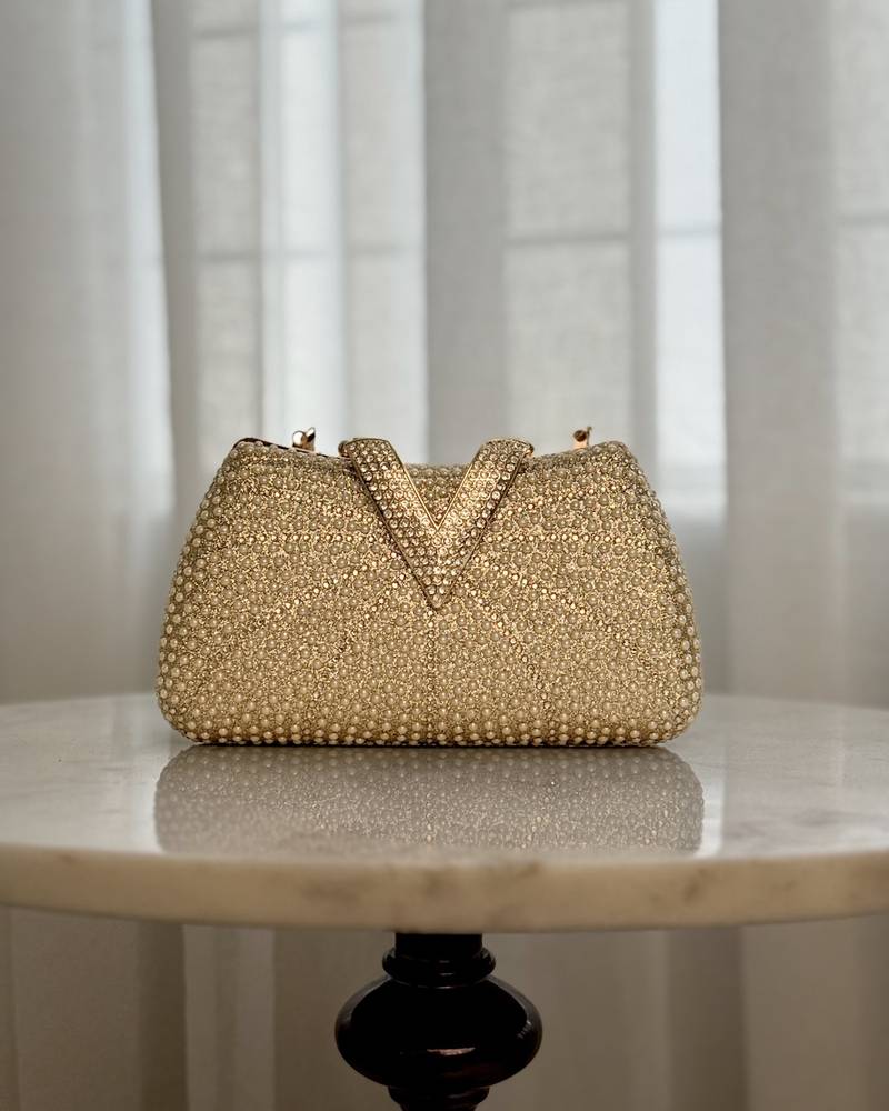 A luxurious occasion bag adorned with pearls and rhinestones