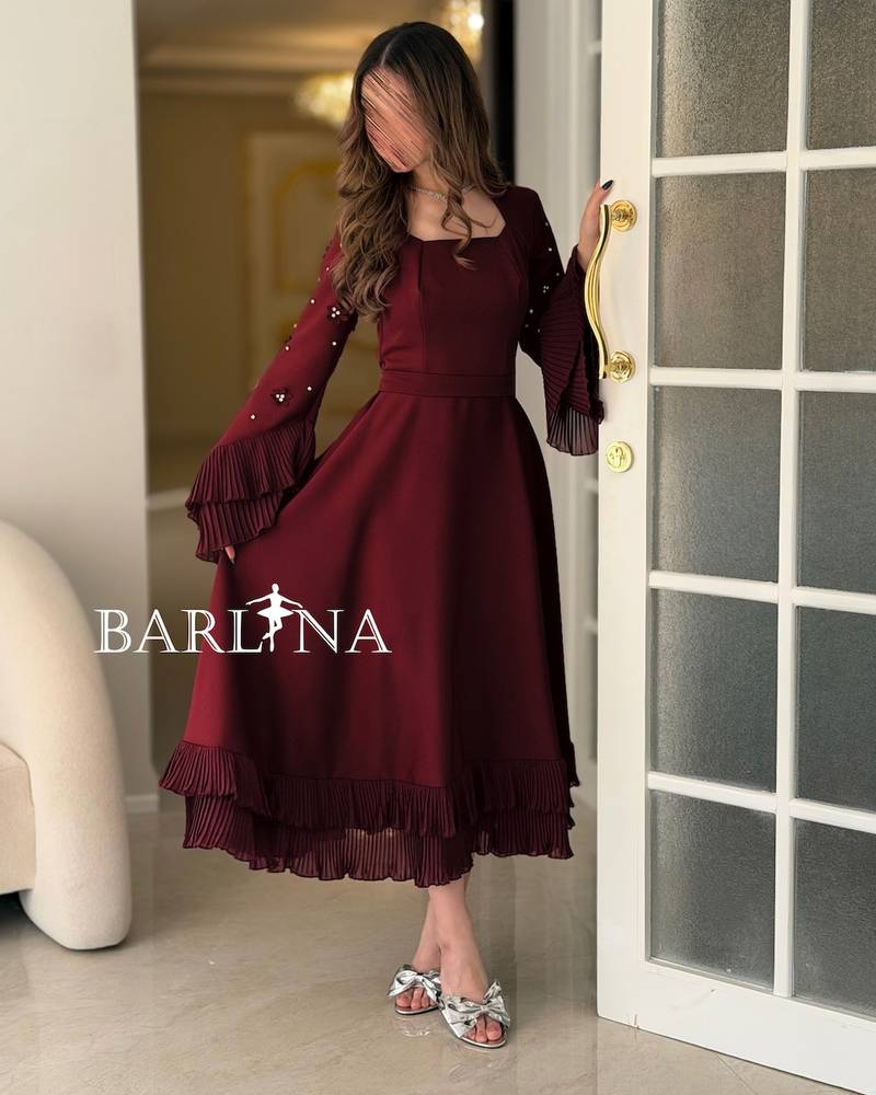Burgundy dress with wide sleeves adorned with crystals