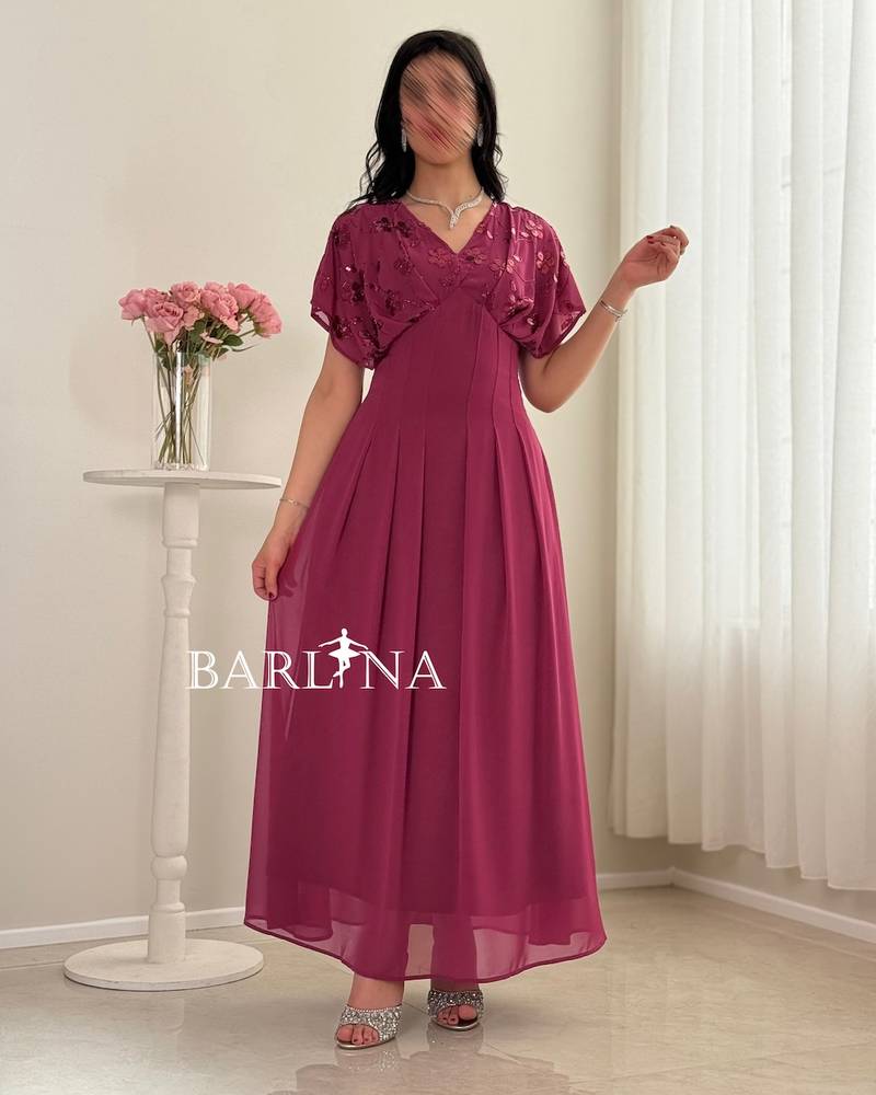 Fuchsia pleated dress with sequined roses