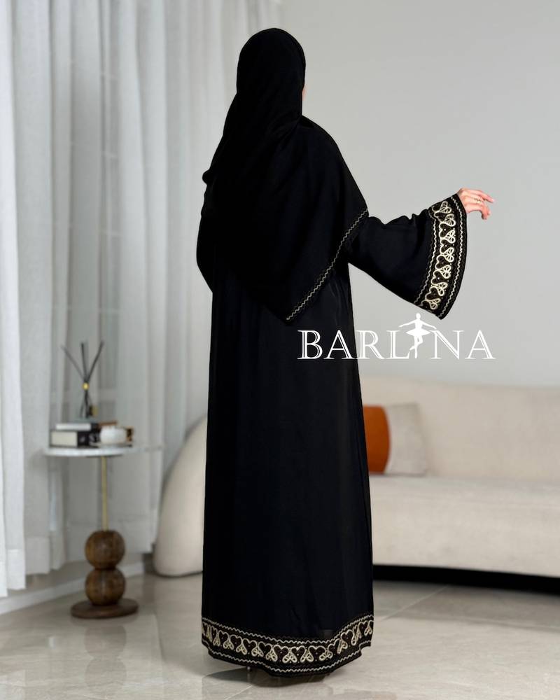 A soft black abaya with prominent beige embroidery