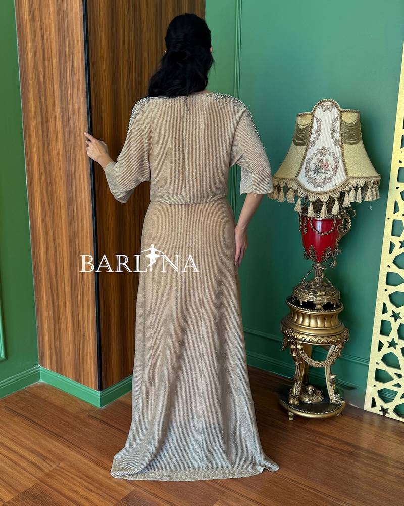 Beige dress with pearl-embellished sleeves