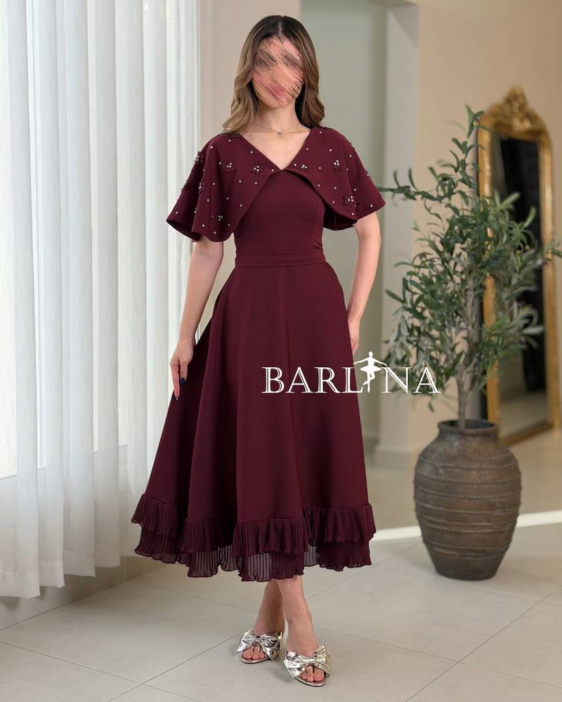 A soft, burgundy flared dress with delicate details