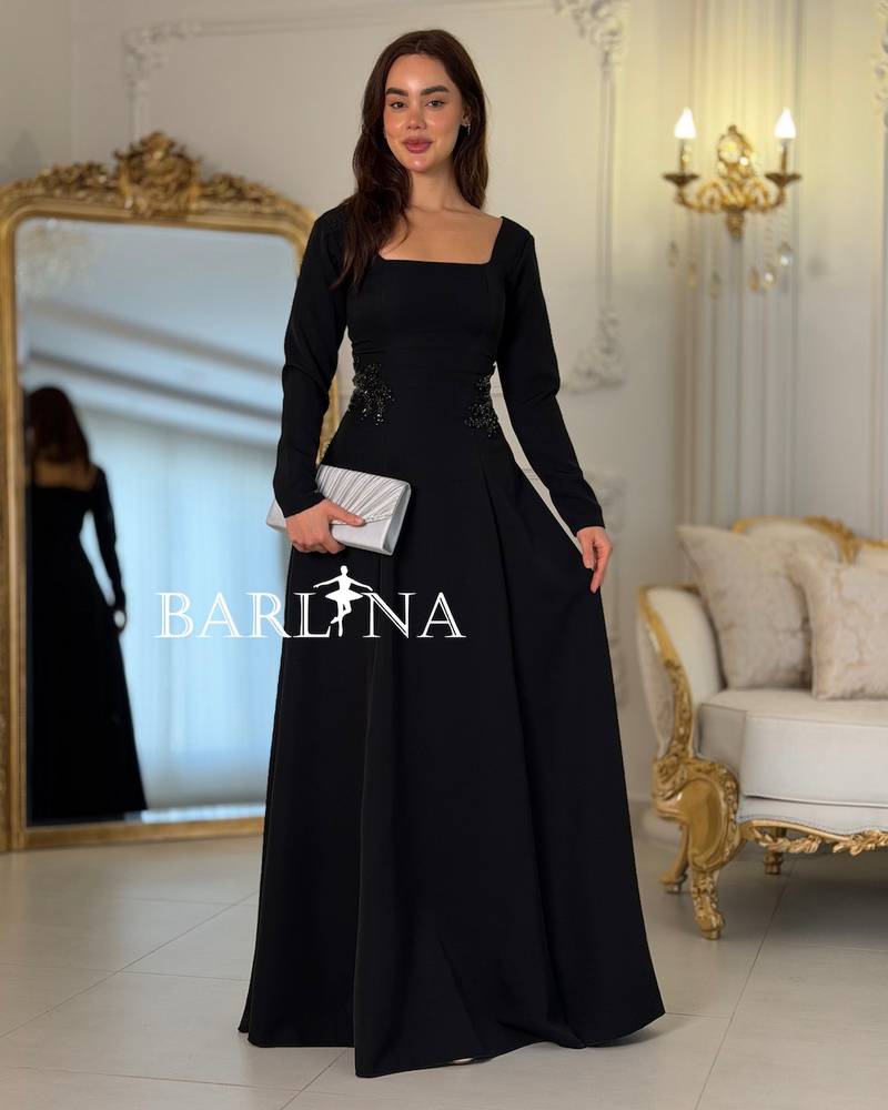 Long black dress with embroidery on the sides