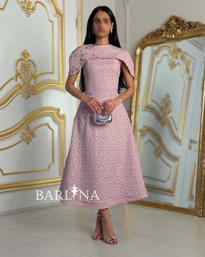 Pink dress with an off-the-shoulder design and decorated with roses